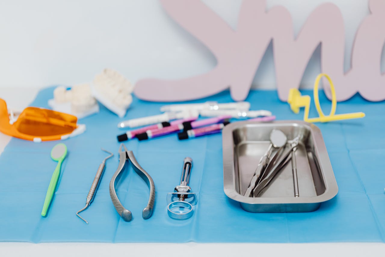Services A set of dental tools neatly arranged on a blue mat, emphasizing modern dentistry.